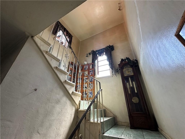 606 W 57th St, Los Angeles, CA 90037 - stairs with tile patterned flooring and a high ceiling