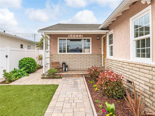 5244 W 137th Pl, Hawthorne, CA 90250 - entrance to property with covered porch, fence, stucco siding, and stone siding
