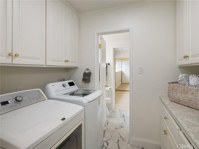 5244 W 137th Pl, Hawthorne, CA 90250 - clothes washing area featuring independent washer and dryer, cabinet space, baseboards, and marble finish floor