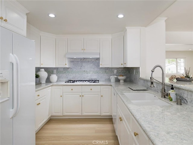 5244 W 137th Pl, Hawthorne, CA 90250 - kitchen with a sink, white cabinets, white refrigerator with ice dispenser, under cabinet range hood, and gas cooktop