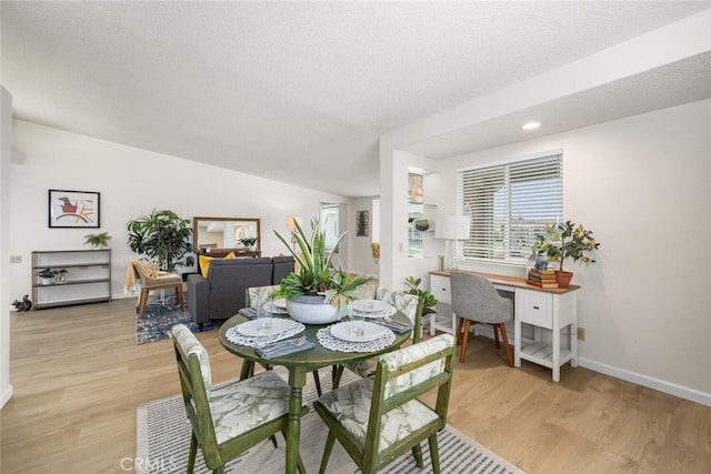 dining area featuring baseboards, light wood-style floors, and recessed lighting
