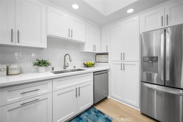 kitchen featuring white cabinets, appliances with stainless steel finishes, and a sink