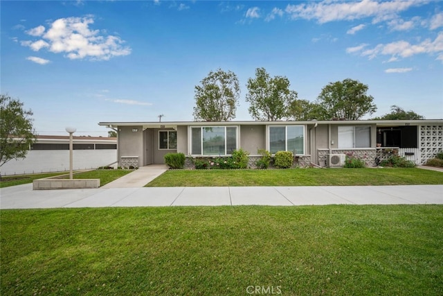 ranch-style house with stone siding, stucco siding, and a front lawn