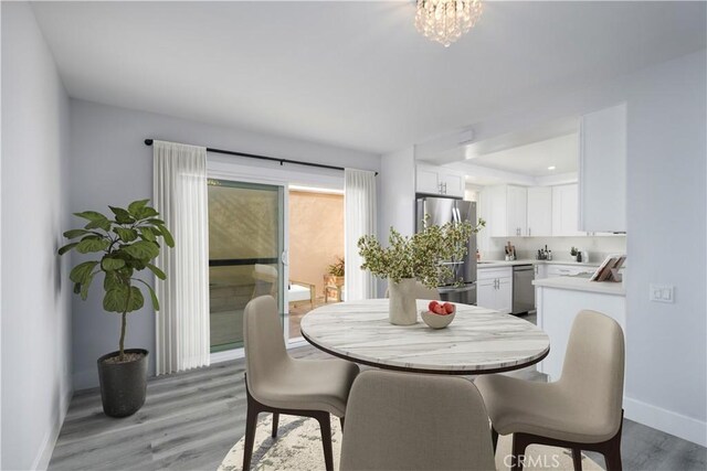 3500 W Manchester Blvd Unit 15, Inglewood, CA 90305 - dining area with a wealth of natural light, baseboards, and light wood-type flooring