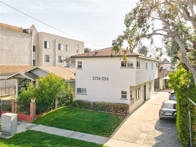 3731 Glendon Ave, Los Angeles, CA 90034 - view of property exterior with a yard, driveway, and stucco siding