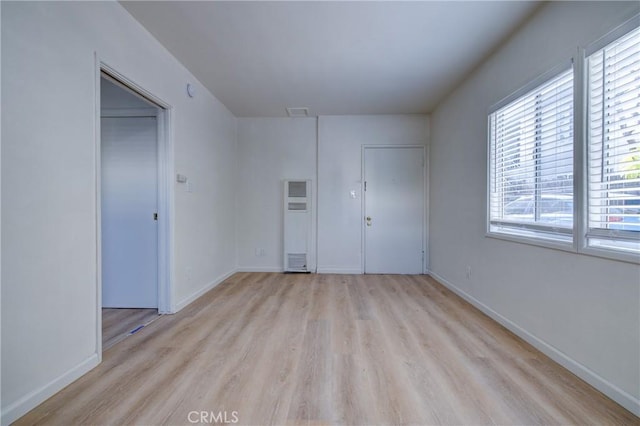 3731 Glendon Ave, Los Angeles, CA 90034 - unfurnished room with a wealth of natural light, light wood finished floors, a heating unit, and visible vents