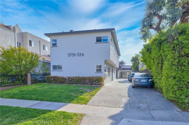 3731 Glendon Ave, Los Angeles, CA 90034 - view of home's exterior with a yard, fence, stucco siding, and concrete driveway