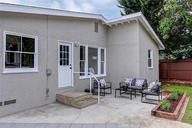 exterior space featuring fence, a patio, stucco siding, and outdoor lounge area