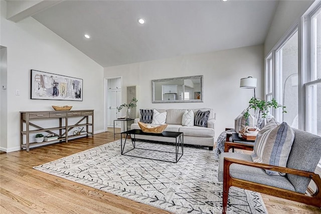 living room featuring wood finished floors, high vaulted ceiling, beam ceiling, baseboards, and recessed lighting