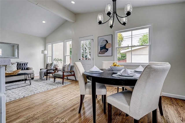 dining room featuring baseboards, an inviting chandelier, vaulted ceiling with beams, and wood finished floors