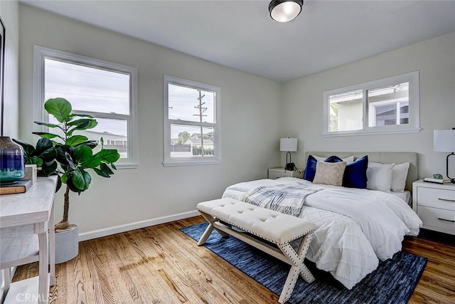 bedroom featuring baseboards and wood finished floors