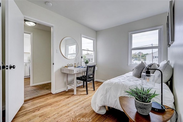 bedroom featuring light wood-style flooring and baseboards