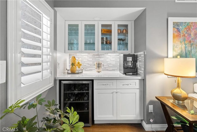 30151 Via Amante, Menifee, CA 92584 - indoor bar with beverage cooler, backsplash, baseboards, and wood finished floors