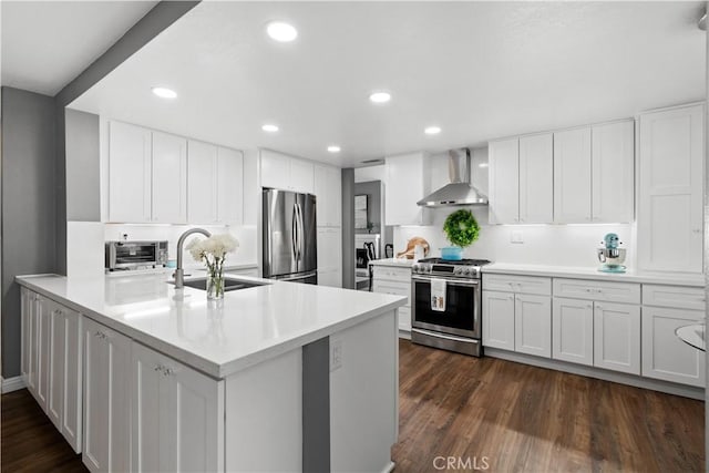 30151 Via Amante, Menifee, CA 92584 - kitchen with stainless steel appliances, wall chimney exhaust hood, a sink, white cabinetry, and recessed lighting