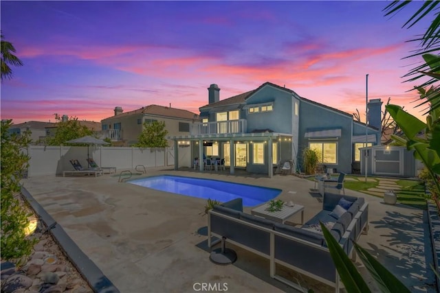 30151 Via Amante, Menifee, CA 92584 - rear view of house with a balcony, a patio area, a fenced backyard, a chimney, and stucco siding