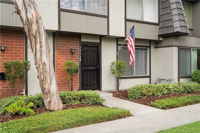 17730 Regency Cir, Bellflower, CA 90706 - view of exterior entry featuring brick siding, stucco siding, and mansard roof