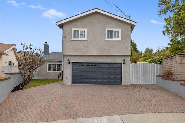 867 W Battery St, San Pedro, CA 90731 - exterior space with an attached garage, a gate, stucco siding, a chimney, and decorative driveway