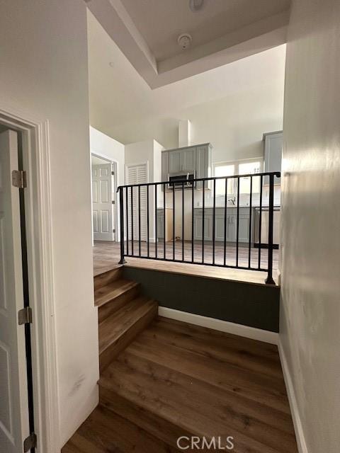 5507 S Manhattan Pl, Los Angeles, CA 90062 - stairs featuring wood finished floors and baseboards