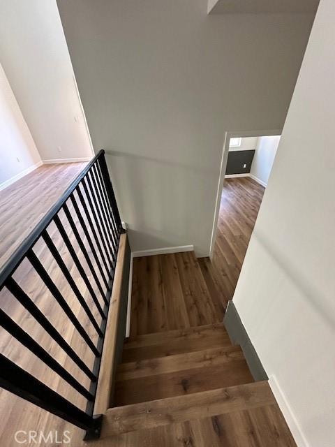 5507 S Manhattan Pl, Los Angeles, CA 90062 - stairway featuring baseboards and wood finished floors