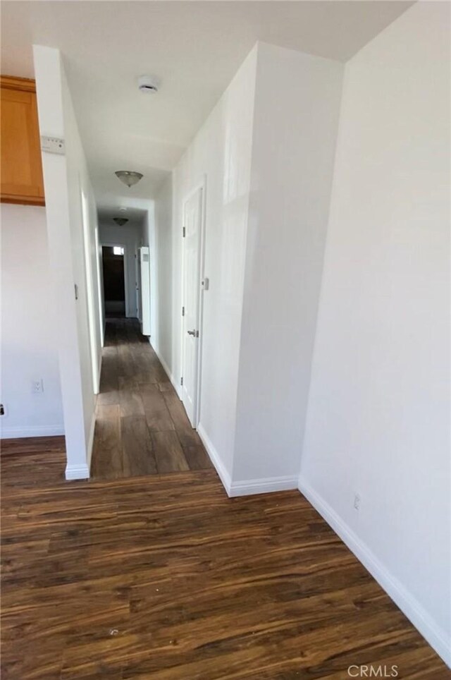 5507 S Manhattan Pl, Los Angeles, CA 90062 - hall featuring baseboards and dark wood-style flooring