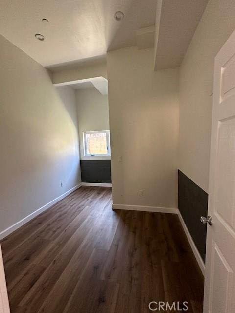 5507 S Manhattan Pl, Los Angeles, CA 90062 - spare room with baseboards and dark wood-style floors