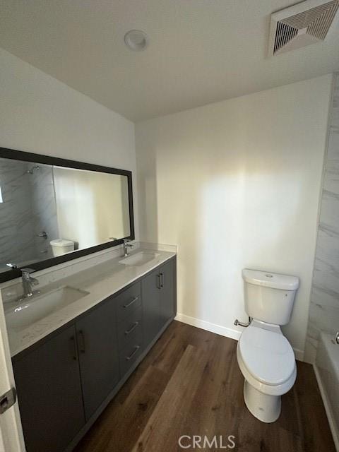 5507 S Manhattan Pl, Los Angeles, CA 90062 - bathroom with toilet, visible vents, and a sink