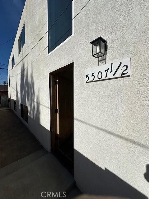 5507 S Manhattan Pl, Los Angeles, CA 90062 - view of exterior entry featuring stucco siding