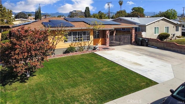 2517 E Walnut Crk, West Covina, CA 91791 - ranch-style home with an attached garage, concrete driveway, solar panels, a gate, and a mountain view