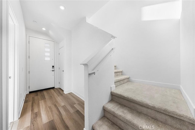 foyer featuring stairway, recessed lighting, baseboards, and wood finished floors