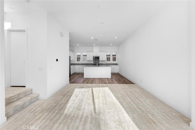 unfurnished living room featuring carpet floors and recessed lighting
