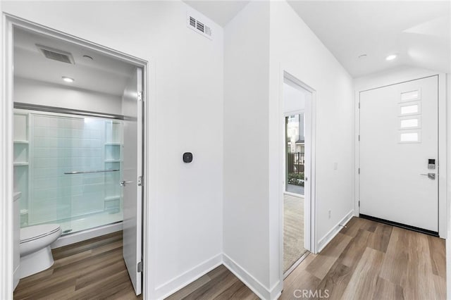 entrance foyer with baseboards, recessed lighting, visible vents, and wood finished floors