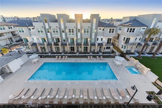 pool featuring a patio, a residential view, and fence