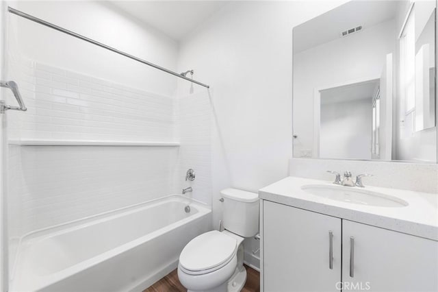 full bathroom with toilet, wood finished floors, vanity, visible vents, and  shower combination