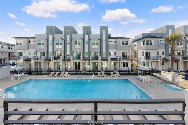 pool featuring fence and a residential view