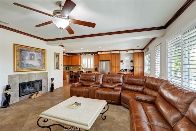 31710 Waterfall Way, Murrieta, CA 92563 - living room featuring ornamental molding, visible vents, a fireplace, ceiling fan, and light tile patterned floors