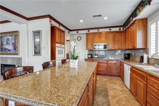 31710 Waterfall Way, Murrieta, CA 92563 - kitchen featuring a sink, stainless steel appliances, visible vents, backsplash, and a center island