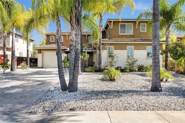 31710 Waterfall Way, Murrieta, CA 92563 - view of front of home featuring fence, a garage, stucco siding, and driveway