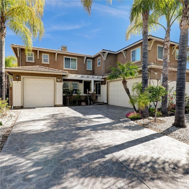 31710 Waterfall Way, Murrieta, CA 92563 - view of front of house with stucco siding, a garage, and decorative driveway