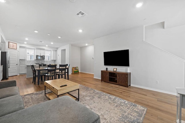 40603 Melrose Dr, Temecula, CA 92591 - living area with baseboards, light wood-type flooring, visible vents, and recessed lighting