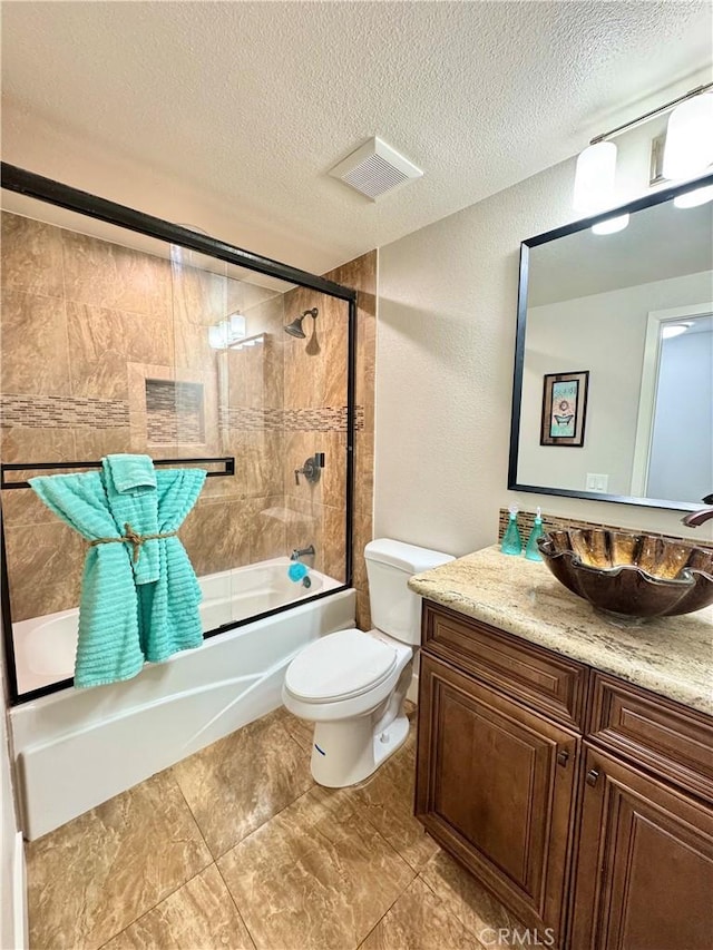 9556 Bloomfield St, Cypress, CA 90630 - bathroom with vanity, toilet, bath / shower combo with glass door, a textured ceiling, and a textured wall