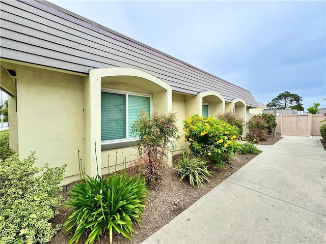 9556 Bloomfield St, Cypress, CA 90630 - view of side of property featuring stucco siding and fence