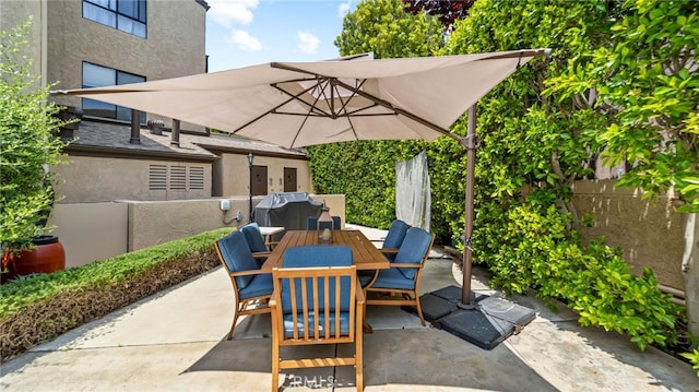 view of patio / terrace featuring outdoor dining area, fence, and grilling area