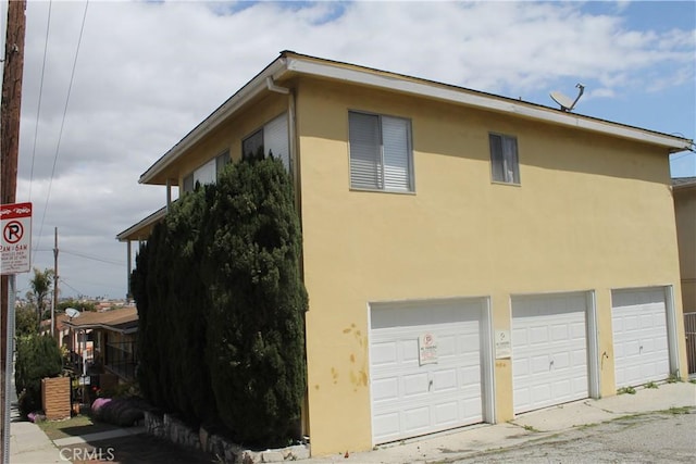 view of home's exterior featuring an attached garage and stucco siding