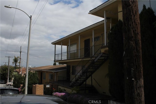 exterior space featuring stairway and a porch