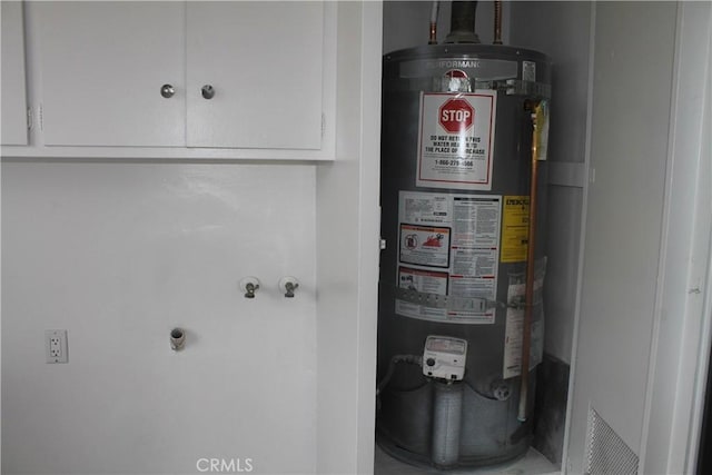 utility room featuring gas water heater