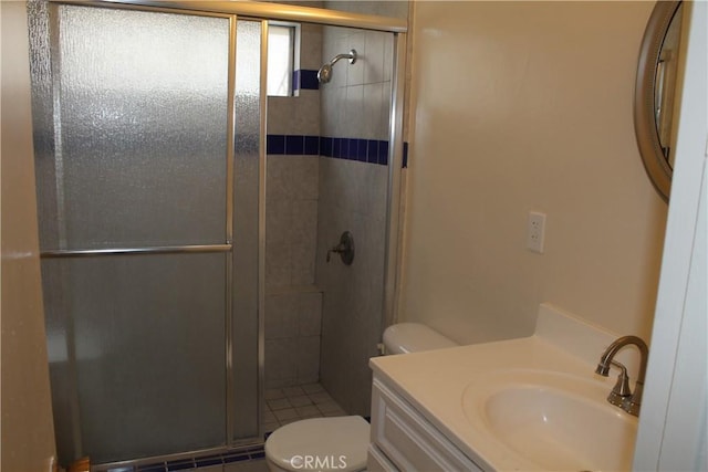 full bath with a stall shower, vanity, and toilet