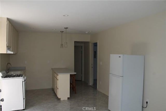 kitchen with light tile patterned floors, white appliances, hanging light fixtures, a sink, and a peninsula