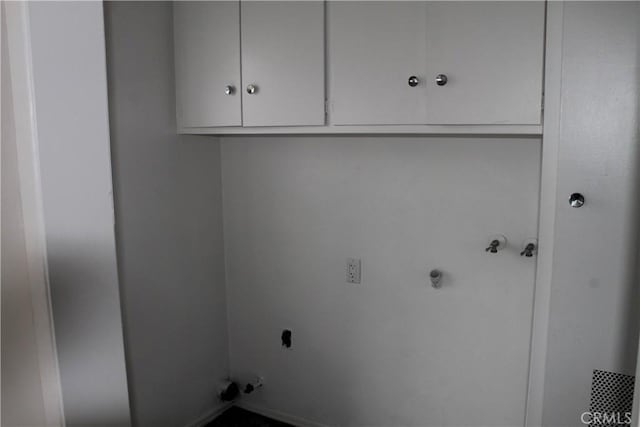 laundry area with cabinet space and hookup for an electric dryer