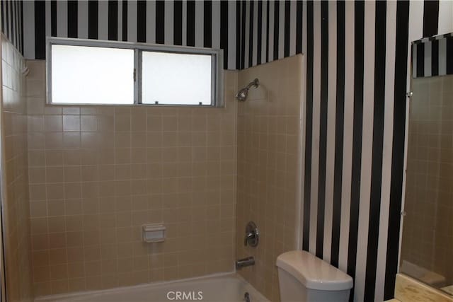 full bathroom featuring toilet, tub / shower combination, and wallpapered walls