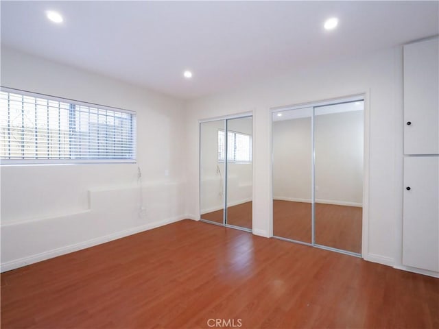 2302 S Gaffey St Unit 1, San Pedro, CA 90731 - unfurnished bedroom featuring wood finished floors, two closets, recessed lighting, and baseboards